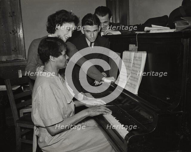 Teacher and student at piano, Jewish Settlement, 1938. Creator: Unknown.