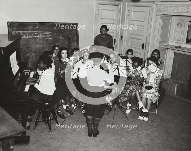 Music classes, tambourines and piano, 1938. Creator: Aubrey Pollard.