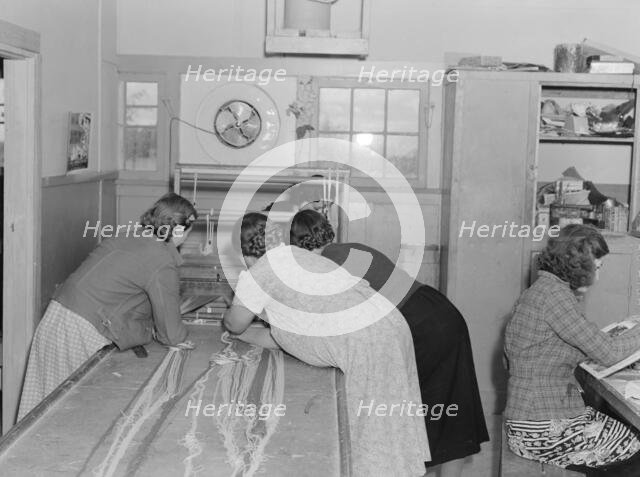 In the sewing room, Shafter camp for migrants (FSA), California, 1938. Creator: Dorothea Lange.