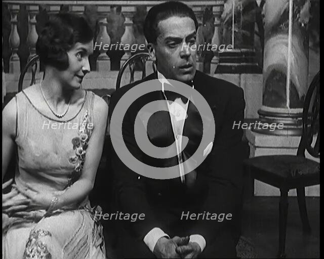 Jack Buchanan and June Knight Sitting on a Bench Together. Buchanan Looking Uncomfortable...,1920s Creator: British Pathe Ltd.