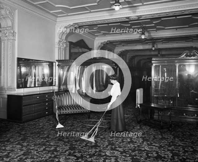 Vacuum cleaner demonstration, Frederick Gorringe's Department Store, London, 1910. Artist: Henry Bedford Lemere.