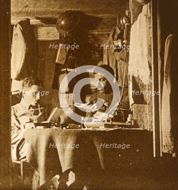 Reading in the trenches, c1914-c1918. Artist: Unknown.