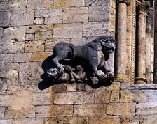 Church of San Pedro de Besalu, lion protecting a human figure and decorating the front window of …