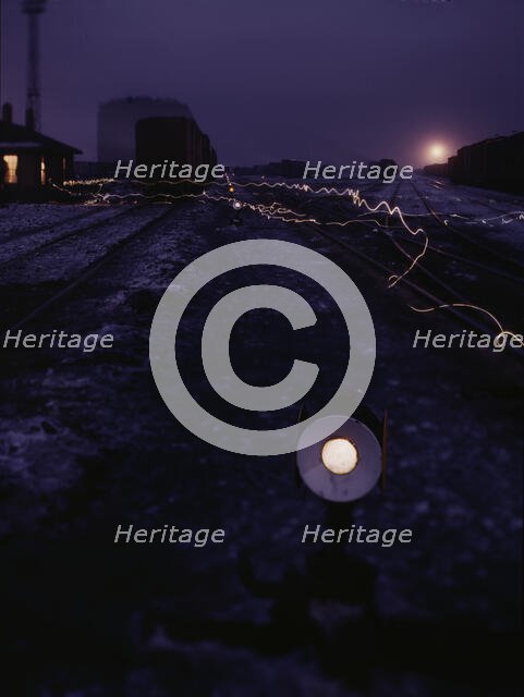 View in a departure yard at C & NW RR's Proviso (?) yard at twilight, Chicago, Ill., 1942. Creator: Jack Delano.