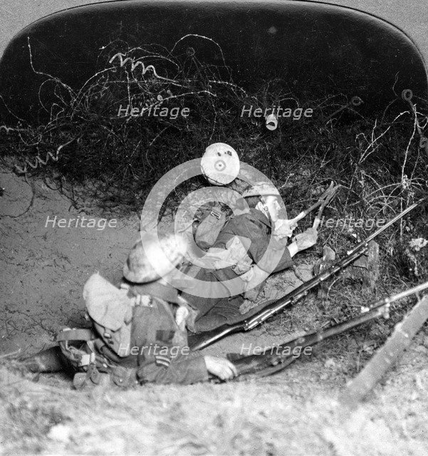 Soldiers cutting through barbed wire defences, Oppy, France, World War I, 1914-1918.Artist: Realistic Travels Publishers