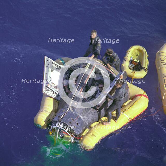 Gemini VIII splashdown, Armstrong and Scott with hatches open, March 16, 1966.  Creator: NASA.