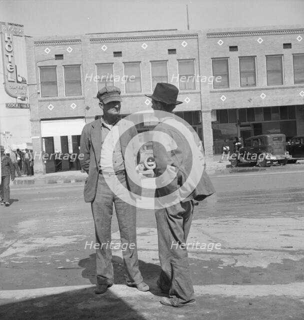 Idle pea pickers discuss prospects for work, Calipatria, Imperial Valley, CA, 1939. Creator: Dorothea Lange.