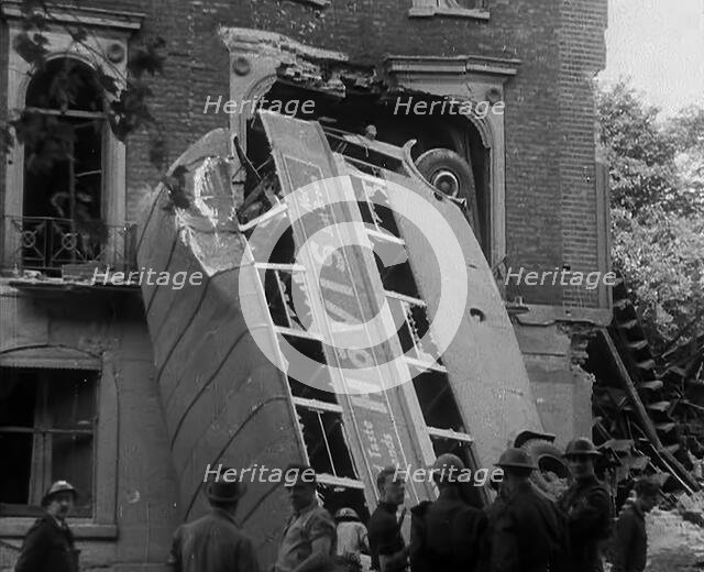 People Standing Next to a Bombed Out Bus, 1940. Creator: British Pathe Ltd.