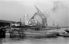 A crane unloads cargo from the 'Makalla' in Tilbury Docks, Essex, c1945-c1965. Artist: SW Rawlings