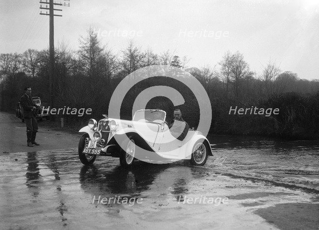 972 cc Singer Le Mans driving through a ford during a motoring trial, 1936. Artist: Bill Brunell.