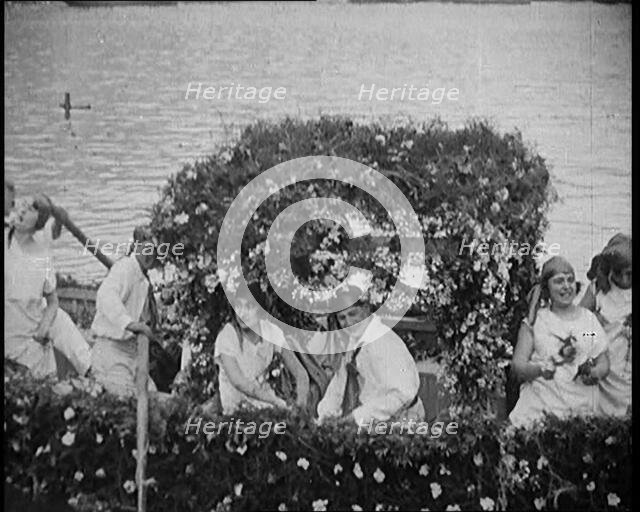 Civilians on a Boat Heavily Decorated with Flowers, 1920. Creator: British Pathe Ltd.