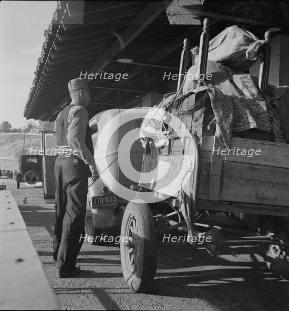 Drought refugees are stopped at the inspection station in Yuma, Arizona, 1937. Creator: Dorothea Lange.