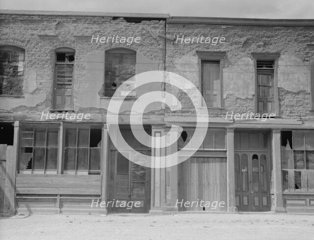 Crumbling buildings in Tombstone, Arizona, once a thriving mining town, 1937. Creator: Dorothea Lange.