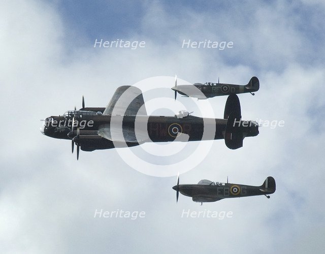 2011 Goodwood Revival Meeting, Lancaster bomber and 2 Spitfires in aerial display. Artist: Unknown.