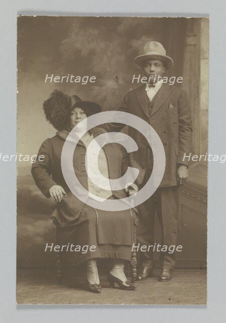 Photographic print of a woman sitting and a man standing, ca. 1850-1895. Creator: Unknown.