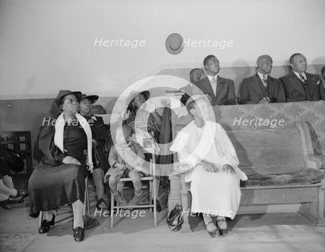 Deacon's corner in the Church of God in Christ, Washington, D.C., 1942. Creator: Gordon Parks.