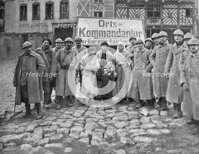 'En territoire libere; Dans Roye delivre le 17 mars: soldats et habitants devant l'ecriteau decroche Creator: Unknown.