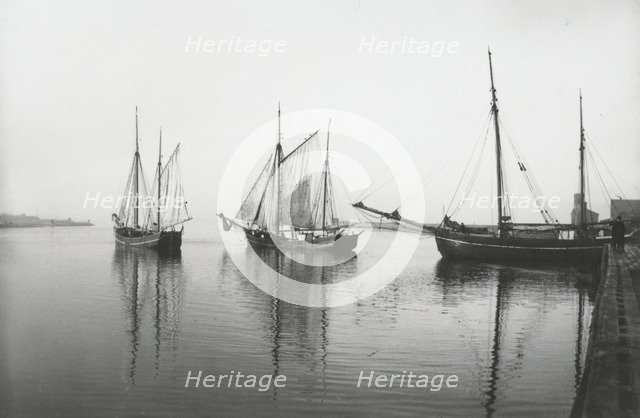 Sailing ships leave the harbour of Landskrona in dead calm conditions, Sweden, 1903. Artist: Unknown