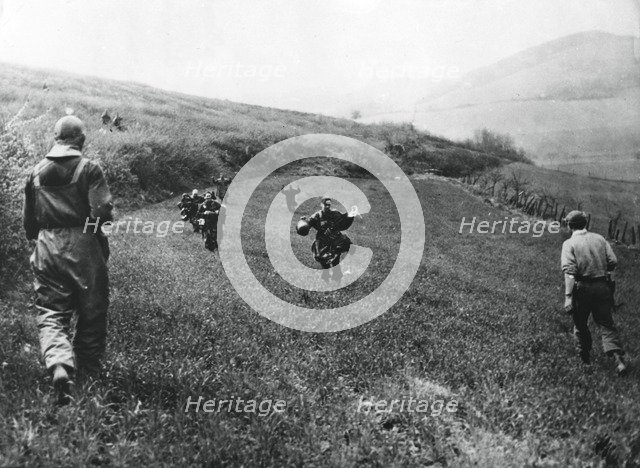 German troops surrendering to soldiers of the American 1st Army, near Elsborn, Germany, April 1945. Artist: Unknown