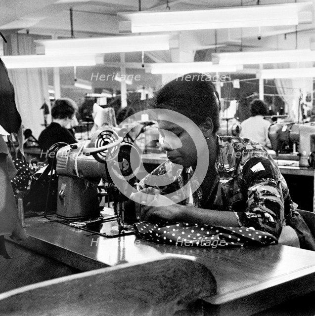 Woman working at a sewing machine, London, (c1955-c1975?). Artist: Henry Grant