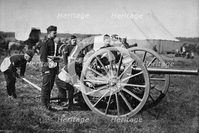 Gunners of field artillery drilling with a 12 pounder, 1895. Artist: Gregory & Co
