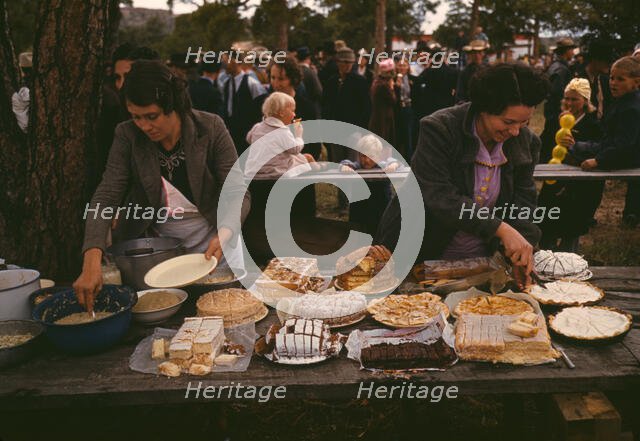 Cutting the pies and cakes at the barbeque dinner, Pie Town, New Mexico Fair, 1940. Creator: Russell Lee.
