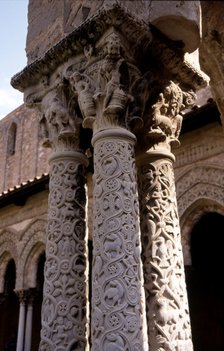 Capitals and carved columns in the Monreale Cathedral cloister in Sicily. The cathedral is Norman…
