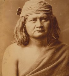 Native man, head-and-shoulders portrait, facing front, c1903. Creator: Edward Sheriff Curtis.