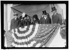 Woodrow Wilson and wife Ellen with unidentified on viewing stand, between 1910 and 1914. Creator: Harris & Ewing.