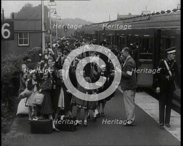 British Male and Female Evacuees on the Platform of a Small Station in the British Country..., 1939. Creator: British Pathe Ltd.