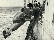 Hoisting a Chariot manned torpedo on board a ship, World War II, 1945. Creator: Unknown.