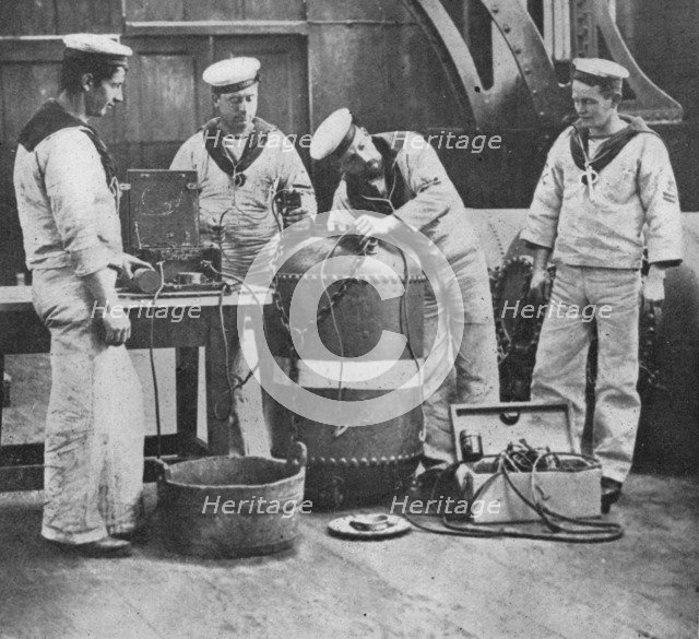 'Fitting up an Electric Contact Mine', 1914. Artist: Unknown.