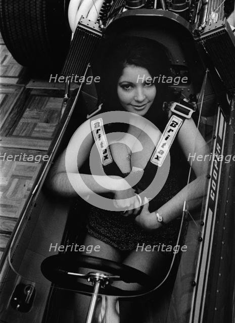 Female model in cockpit of Cooper F5000 at 1969 Racing Car show. Creator: Unknown.