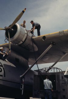 Fueling a plane at the Naval Air Base, Corpus Christi, Texas, 1942. Creator: Howard Hollem.