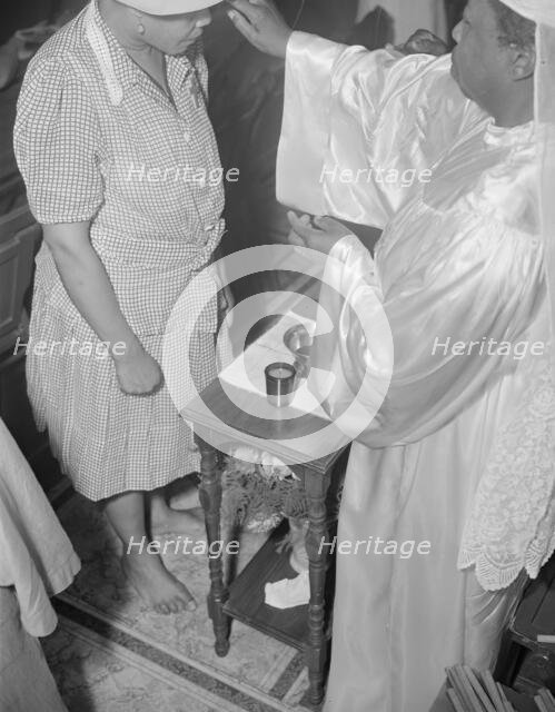 Reverend Clara Smith anointing a member of the St. Martin's Spiritual... Washington, D.C., 1942. Creator: Gordon Parks.