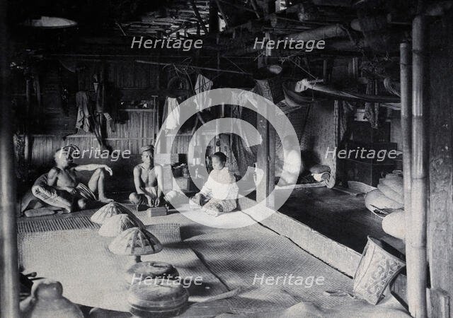Sarawak: interior of a Kadayan tribal house, with a meal laid out, c1900. Creator: Unknown.