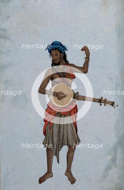 A man wearing a cloth skirt and a turban, playing a musical instrument. Creator: Unknown.