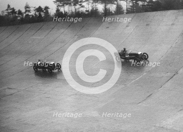 Two Salmsons racing on the banking at a BARC meeting, Brooklands, Surrey, 1931 Artist: Bill Brunell.