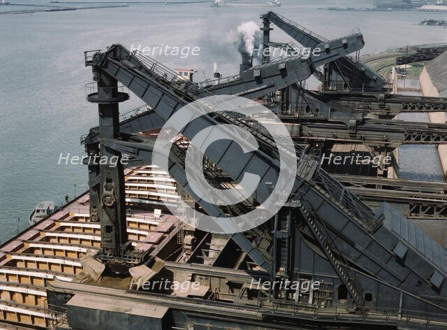 Pennsylvania R.R. ore docks, unloading iron ore from a lake freighter..., Cleveland, Ohio, 1943. Creator: Jack Delano.