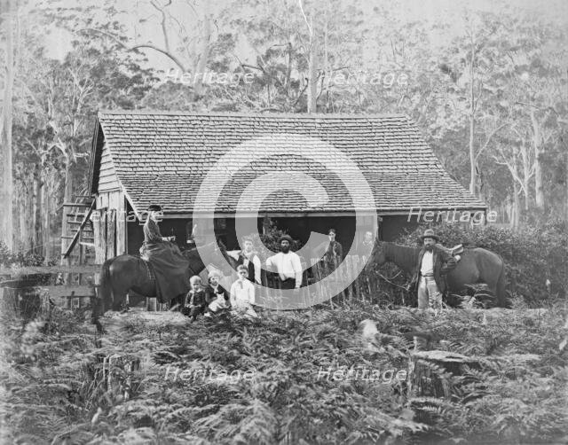 Australian wooden slab hut with large unknown family outside, c1900s. Creator: Robert Augustus Henry L'Estrange.