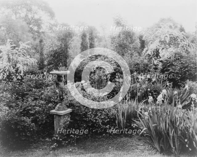 English lead figurine holding sundial, Graham Nichols garden, Greenwich, Connecticut, c1908 - 1927. Creator: Frances Benjamin Johnston.