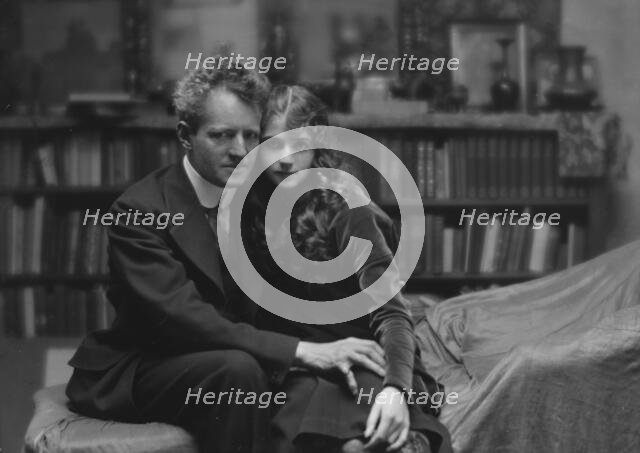 Arnold Genthe seated next to a woman friend in his studio in San Francisco, between 1896 and 1911. Creator: Arnold Genthe.