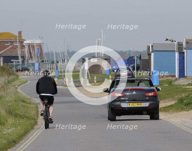 Mitsubishi Colt CZC cabriolet overtaking cyclist
