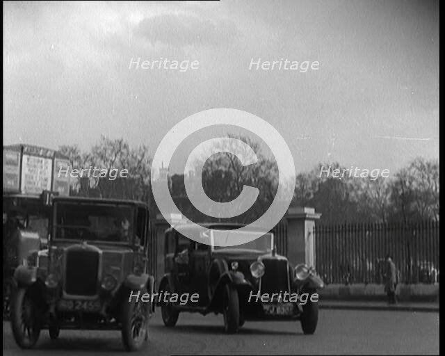 London Bus, Cars and Taxis Turning a Corner on a London Street, 1924. Creator: British Pathe Ltd.