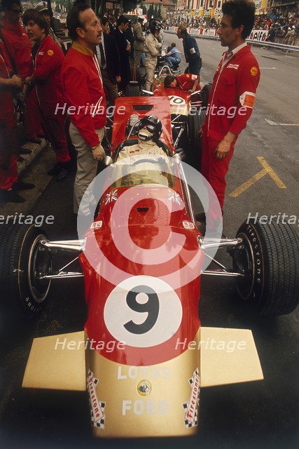 Colin Chapman and a mechanic in discussion over Graham Hill's Lotus, Monaco Grand Prix, 1969. Artist: Unknown