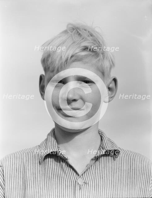 Son of migratory worker from Kansas in squatters' camp near Farmersville, California, 1936. Creator: Dorothea Lange.