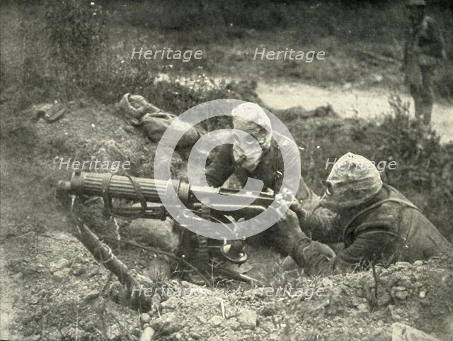 'Machine Gunners in Action Wearing their Gas Helmets', (1919).  Creator: Unknown.