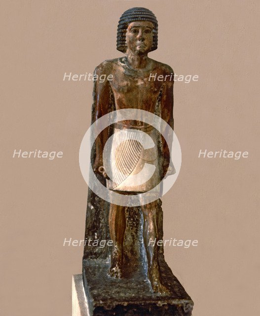 Hieratic statue of a man, made in polychromed limestone.