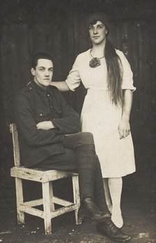 Two prisoners of war, one in drag, pose with a chair, [between 1910 and 1919?]. Creator: Unknown.