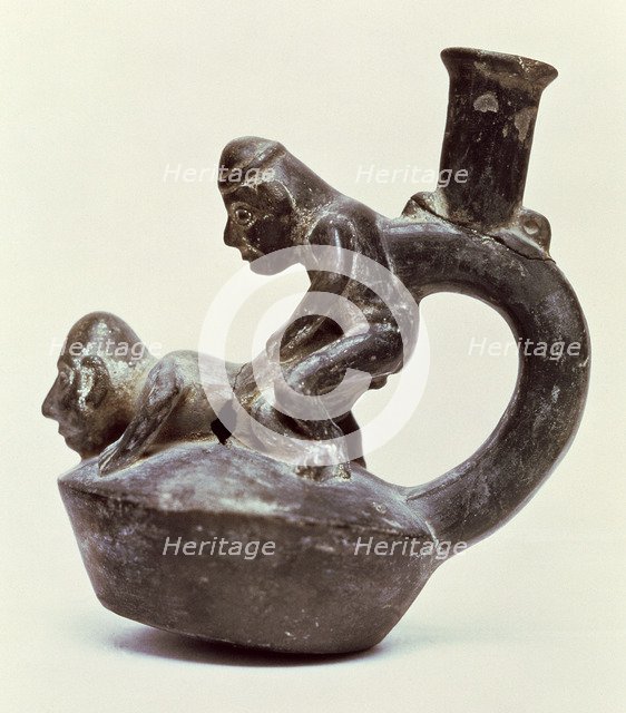 Anthropomorphic Vase with stirrup handle depicting two male persons performing a sex act, belongi…